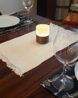 Ola Walnut resting on dining room table with dinner setting and wine glasses.