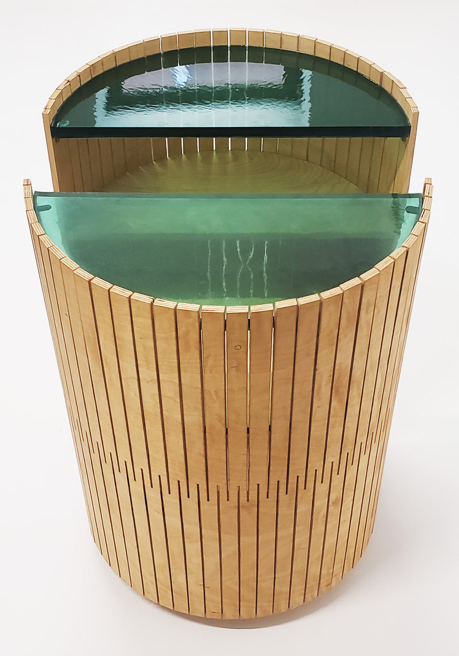 Front view of the side table entitled Laguna Table by Jason Robinson. View highlights the table separated into two parts.